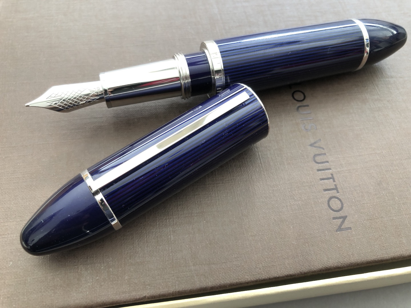 Sold at Auction: Louis Vuitton, LOUIS VUITTON FOUNTAIN PEN CARGO  COLLECTION. IN BLUE LACQUER WITH BLACK STRIPES AND PLATINUM PLATING DETAILS.